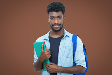 Smiling black male student with beard on brown background