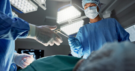 Doctors, team and scissors in theater for surgery, healthcare or medical support and operation room...