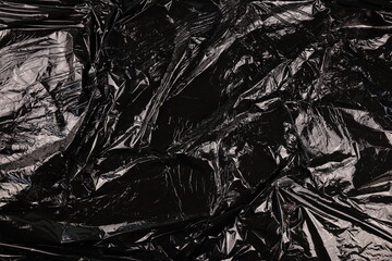Texture of black plastic garbage disposable bag