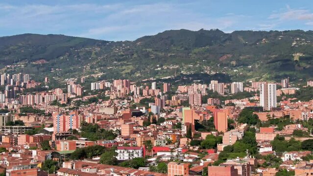 Telephoto aerial over drug cartel city Medellin, Colombia, skyline and mountain