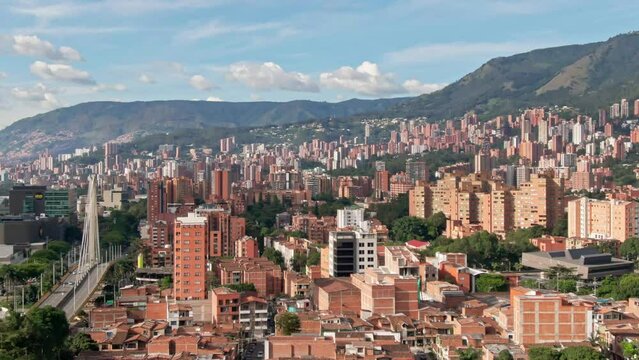 Metropolis city Medellin on a sunny summer day, aerial telephoto establisher