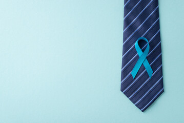 Empowering Men's Health. A bird's-eye view of prostate cancer awareness icon - blue ribbon,...