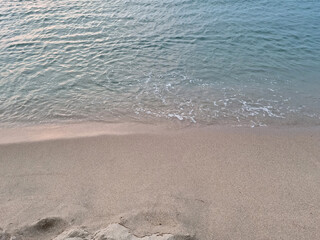 Fototapeta na wymiar Soft beautiful ocean wave on sandy beach. Background