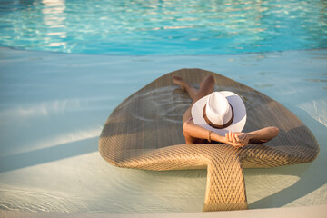 Poolside Paradise: Woman Sunbathing on a Luxury Sunbed