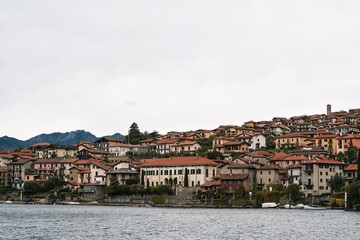 Obraz premium An Italian Village on Como Lake, Milan, Italy, Embraced by Majestic Alps and Lake Waters