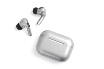 Silver white headphones wireless earphones with case, copy space isolated background.