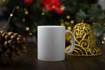 Mockup of coffee cup on table with christmas decoration. Coffee mug with christmas background.