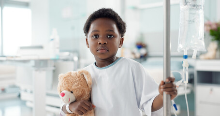 African child, sick in hospital and teddy bear for healthcare, wellness or treatment on iv drip....