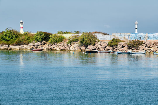 Lighthouse and fishing boats at Akcakoca harbor in Duzce province, Turkey.