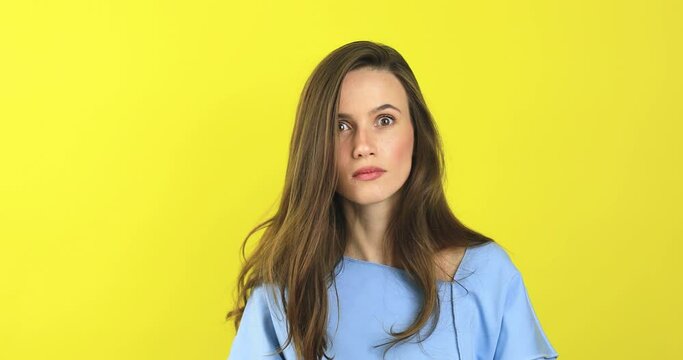 Skeptical beautiful caucasian female wear blue sweater standing on yellow background looking by side, listen and wave head no with disappointment. Confused woman look scary.