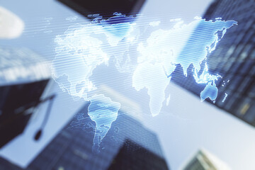 Double exposure of abstract digital world map on modern skyscrapers background, research and strategy concept