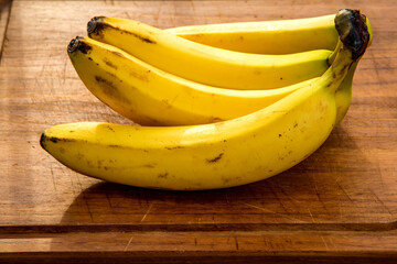 ripe bananas on a kitchen plank