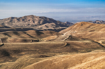 Amazing landscape of Kyrgyzstan. Bizarre hilly formations in Kyrgyzstan. Natural background of the earth's surface.