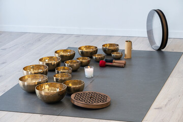 Tibetan singing bowls on the floor in a yoga studio.