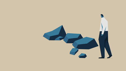 A businessman runs into an obstacle. There are several rocks in front of him.