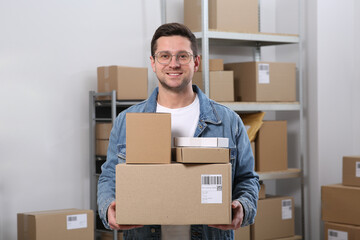 Seller with parcels in office. Online store