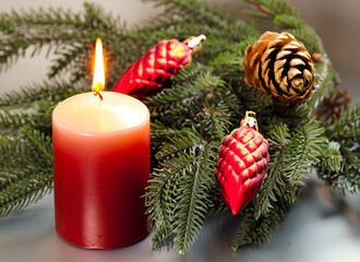 Christmas and New year Holiday Card, Red candle ,  fir tree branches with decorative ornaments on snow