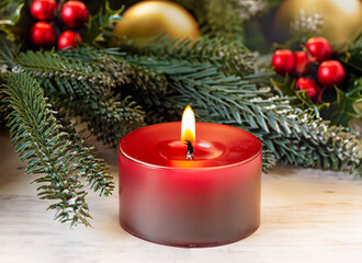 Christmas and New year Holiday Card, Red candle ,  fir tree branches with decorative ornaments on snow