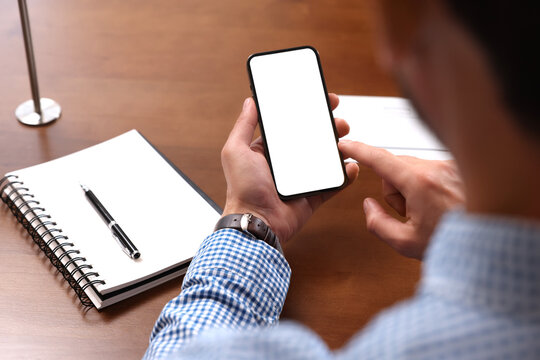 Man Using Smartphone At Table, Closeup View