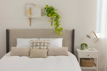 Stylish bedroom interior with large comfortable bed and bedside table