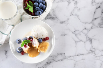 Tasty vanilla fondant with white chocolate, berries and ice cream served on white marble table, flat lay. Space for text