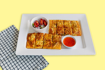 Roti mataba, Muslim food in Thailand. Mataba is stuffed roti with chicken or meat. Eat with cucumber slices, onions and chilies in vinegar.