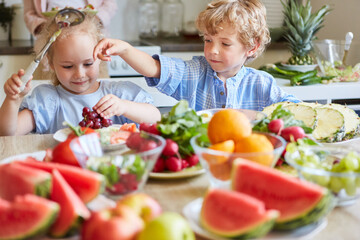 Boy and girl playing with each other in kitchen