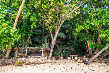 Top Soleil, picturesque beach bar under trees on a sandy beach on the tropical island of Mahé, Seychelles