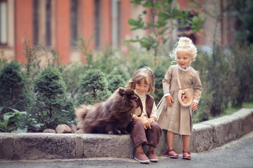 Girl and boy with two dogs on the city street talking and laughing 