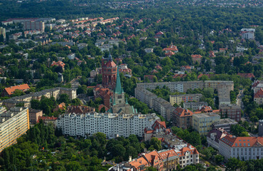 Fototapeta na wymiar Church of St. Augustine and nearest residential buildings, top view from the observation deck of Sky Tower skyscraper in Wroclaw, Poland. 