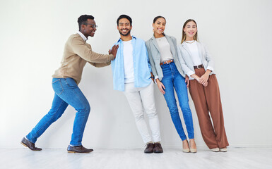 Black man pushing team of business people, portrait and smile in office together for synergy. Strong professional support group of employees, solidarity for collaboration and cooperation in startup