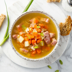 Traditional pea soup with ham and vegetables