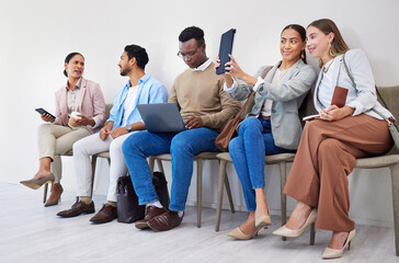 Group of people, waiting room and interview at job recruitment agency with laptop, tablet and resume. Human resources, hiring and business men and women in lobby together with career opportunity.