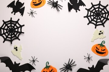 Frame made of bats, pumpkins, ghosts and spiders on white background, space for text. Halloween celebration
