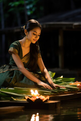 Beautiful women wear festival activities with candlelight and Loy Krathong.