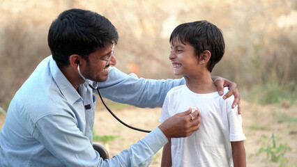 Health checkup, Children medical insurance care. Indian village doctor of pediatrician holding...