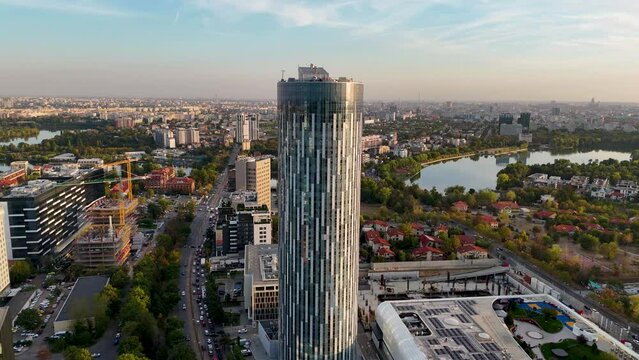 Golden Hour in Bucharest: A Rotating Aerial View of a Tall Office Building