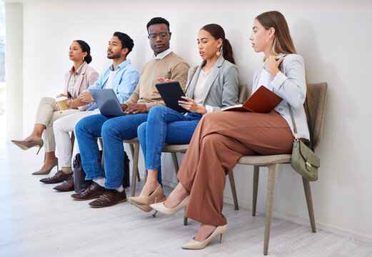 Business people, row and technology for interview, recruitment or hiring process in waiting room. Men, women and group together for career, onboarding or opportunity at company with diversity or web
