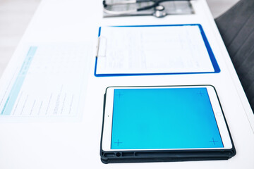 Tablet, screen space and medical documents in healthcare background, services and results on blue app or mockup. Digital technology, paperwork and empty clinic for registration, data or health charts