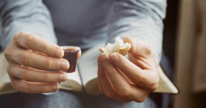 Woman taking communion - bread and wine. Christian faith and practice concept