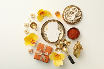 Copper utensils, spices, flowers, gift box and Hamsa on white background, top view