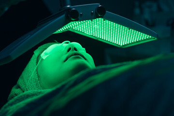 Woman facial cosmetic process with biolight LED laser face skin treatment repair lifting...