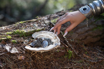 Forest girl taking jewelry from a tree