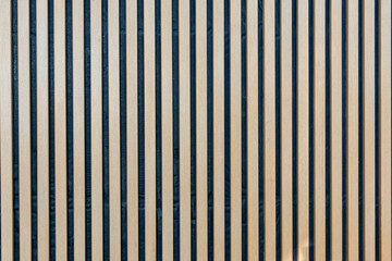A three dimensional vertical seamless pattern of modern wall paneling with vertical wooden slats...