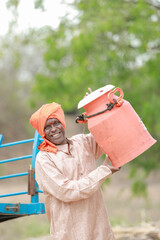 happy Indian farmer selling milk in farm