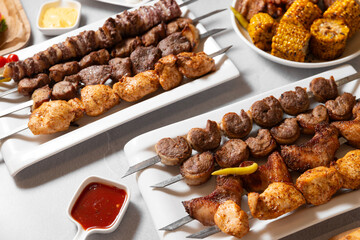 set of different grilled meat and corn on a with plates, grilled food for banner and menu