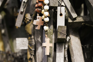 Wooden rosary background. Hanging rosary. Religious background. Mother Mary prayer. Loving Jesus symbol background. Weathered wooden cross.