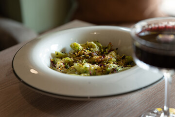 italian pasta on a wooden table with red wine light from the window
