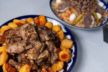 Kazakh beshparmak with meat and fried potato, oriental beshparmak, grilled lamb with fried potato, oriental cuisine, asian cuisine, traditional oriental dish 