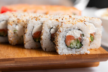 set of sushi rolls on wooden desk close up
